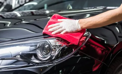 Polishing a headlight with a microfiber cloth