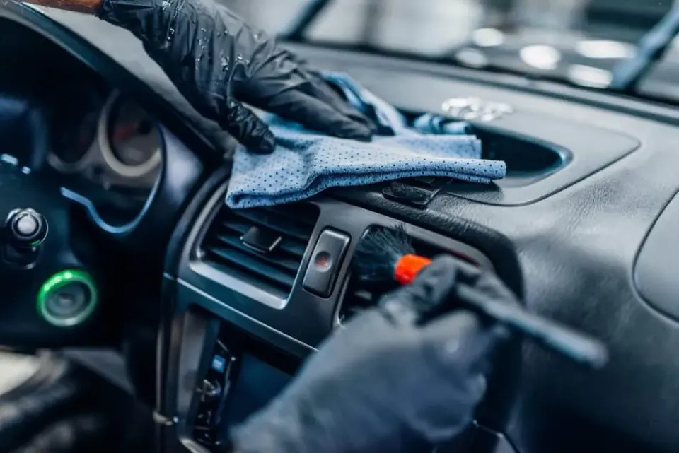 Detailer deep-cleaning a car interior